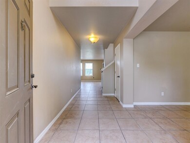 Corridor with light tile patterned floors and bas