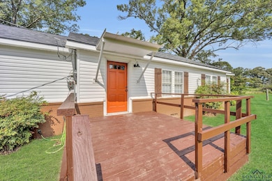 Wooden terrace featuring a yard