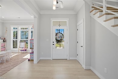 Open foyer with coat closet/storage under stairs