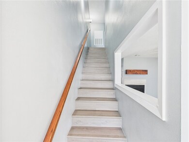 Stairway featuring a fireplace