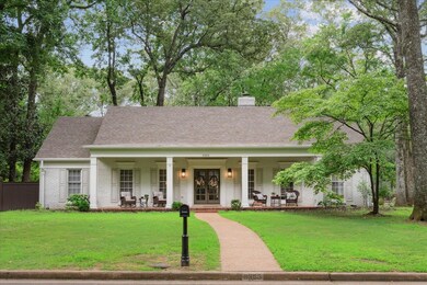 View of front of home with a porch and a front yar