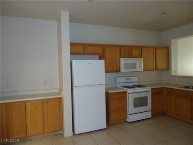 Kitchen featuring light tile patterned floors, lig