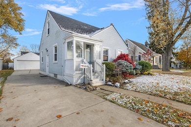Bungalow-style house with an outdoor structure, a detached garage, and a shingled roof