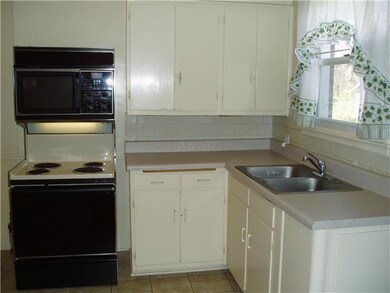 The kitchen has a range/microwave combination with