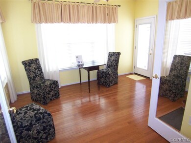 Morning room with hardwood floors, a pass through