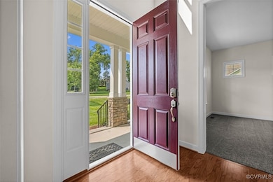 Entrance foyer with wood finished floors and baseb