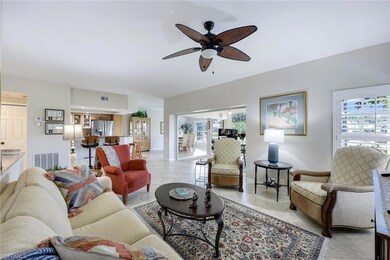 Living room featuring ceiling fan and light tile patterned flooring