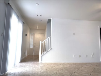 Unfurnished room featuring light tile patterned fl