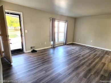 Spare room with dark wood-type flooring