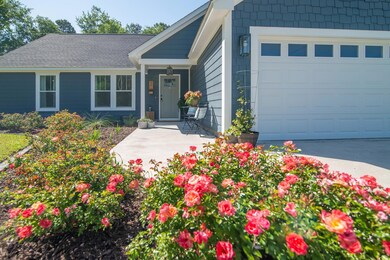 Single story home featuring concrete driveway and 