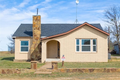 View of front of house featuring brick, a front ya
