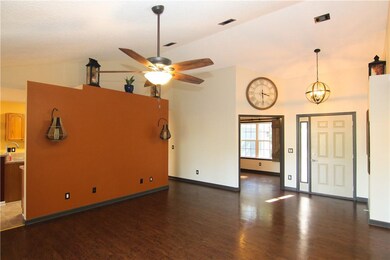 Other view of living room with kitchen wall.