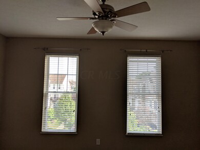 Front room with ceiling fan, windows