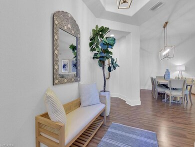 Sitting room with baseboards, visible vents, and wood finished floors