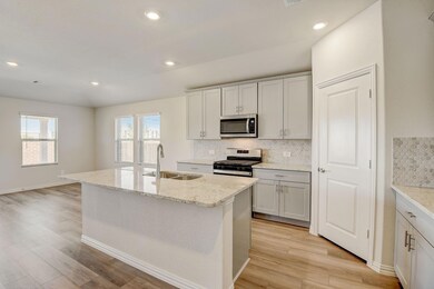 Kitchen with sink, stainless steel appliances, tas