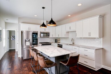 The kitchen is stunning with quartz countertops, n