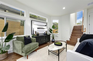 Living area with stairway, plenty of natural ligh
