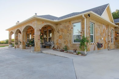 View of home's exterior featuring stone siding, r