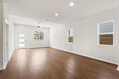 Spare room with ceiling fan, dark wood-style floo