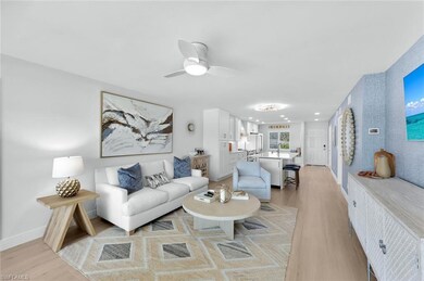 Living room with ceiling fan and light hardwood / 