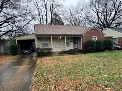 Ranch-style home with a front lawn and a carport
