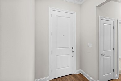 Doorway to outside featuring dark wood-style floor