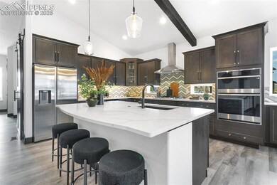 Kitchen featuring backsplash, dark brown cabinetry, stainless steel appliances, a kitchen island with sink, and recessed lighting