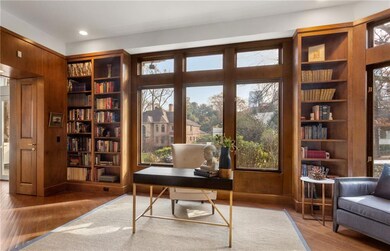 Office with built in features, wood finished floors, and recessed lighting