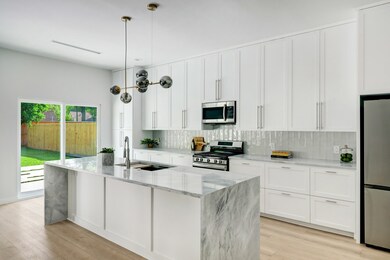 Island kitchen with breakfast bar seating, waterfa