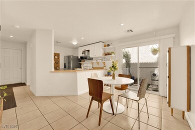 Dining space with light tile patterned floors, vis