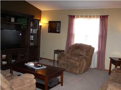 The living room has very nice neutral carpet.