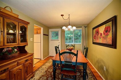Formal dining room with hardwood floors and door t