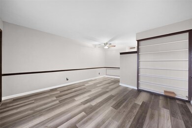 Unfurnished room featuring ceiling fan and wood-ty