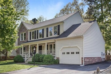 Front view showing double-width paved driveway (an