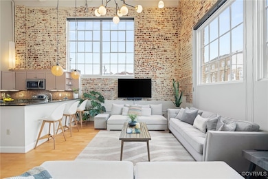 Living room with sink, a chandelier, brick wall, l