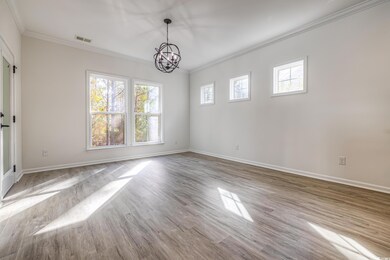Empty room with a notable chandelier, light wood-t