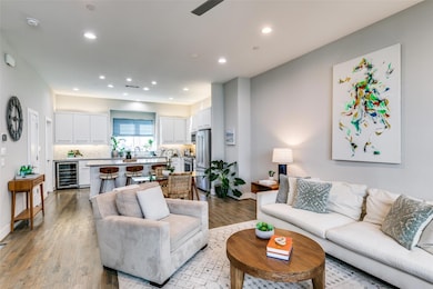 Living room featuring wine cooler, light hardwood 