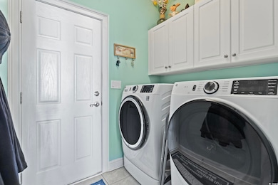 Laundry area featuring washer and dryer, light til
