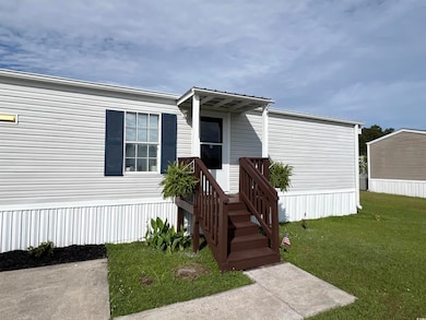Manufactured / mobile home with a front lawn