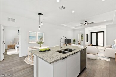 Kitchen with decorative light fixtures, sink, whit