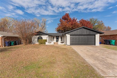 Single story home featuring a front lawn and a gar