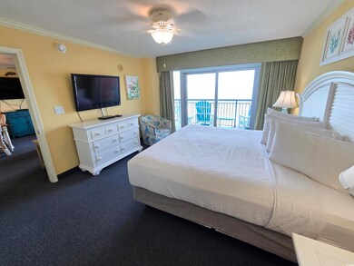 Bedroom with access to outside, ornamental molding, dark carpet, and a ceiling fan