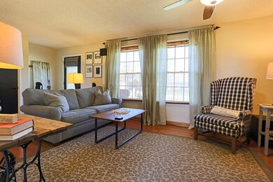 Hardwood floors and double windows are some of the gorgeous features in this den