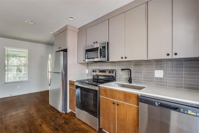 Kitchen with dark hardwood / wood-style floors, ba