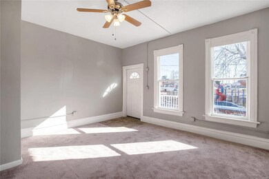 Unit 1 - Living room with large bright windows, ne