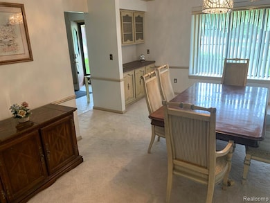 Dining area with a chandelier and light colored carpet
