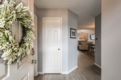 As you walk in the front door, there is a door on