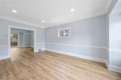 Spare room featuring light hardwood / wood-style floors and ornamental molding