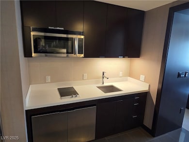 Kitchen with stainless steel microwave, modern cab