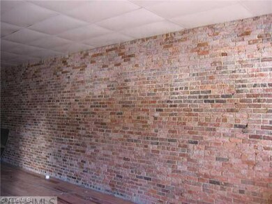 Interior Space/Layout. Unit 3. Street entrance. Open. Drop ceiling. Wood floor. Rear loading door. Brick walls.